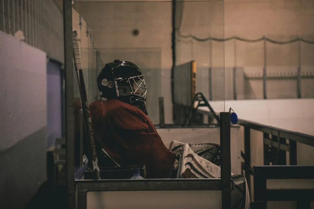 Hockey goalie preparing in locker room before game representing athlete mental preparation